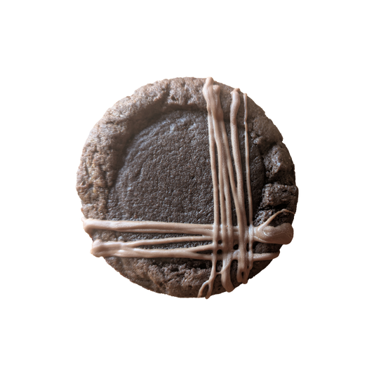 Picture of a dark chocolate cookie stuffed with soft brownie and drizzled with milk chocolate