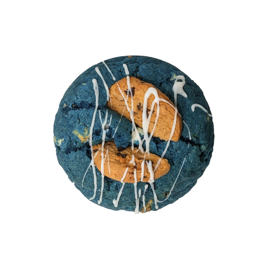 Picture of a blue cookie stuffed with white chocolate, cookies and cream topped with a splash of white icing.