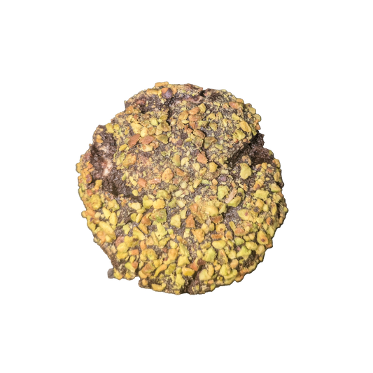 Picture of a dark cookie stuffed with Pistachio and milk chocolate covered in  crushed Pistachio pieces.