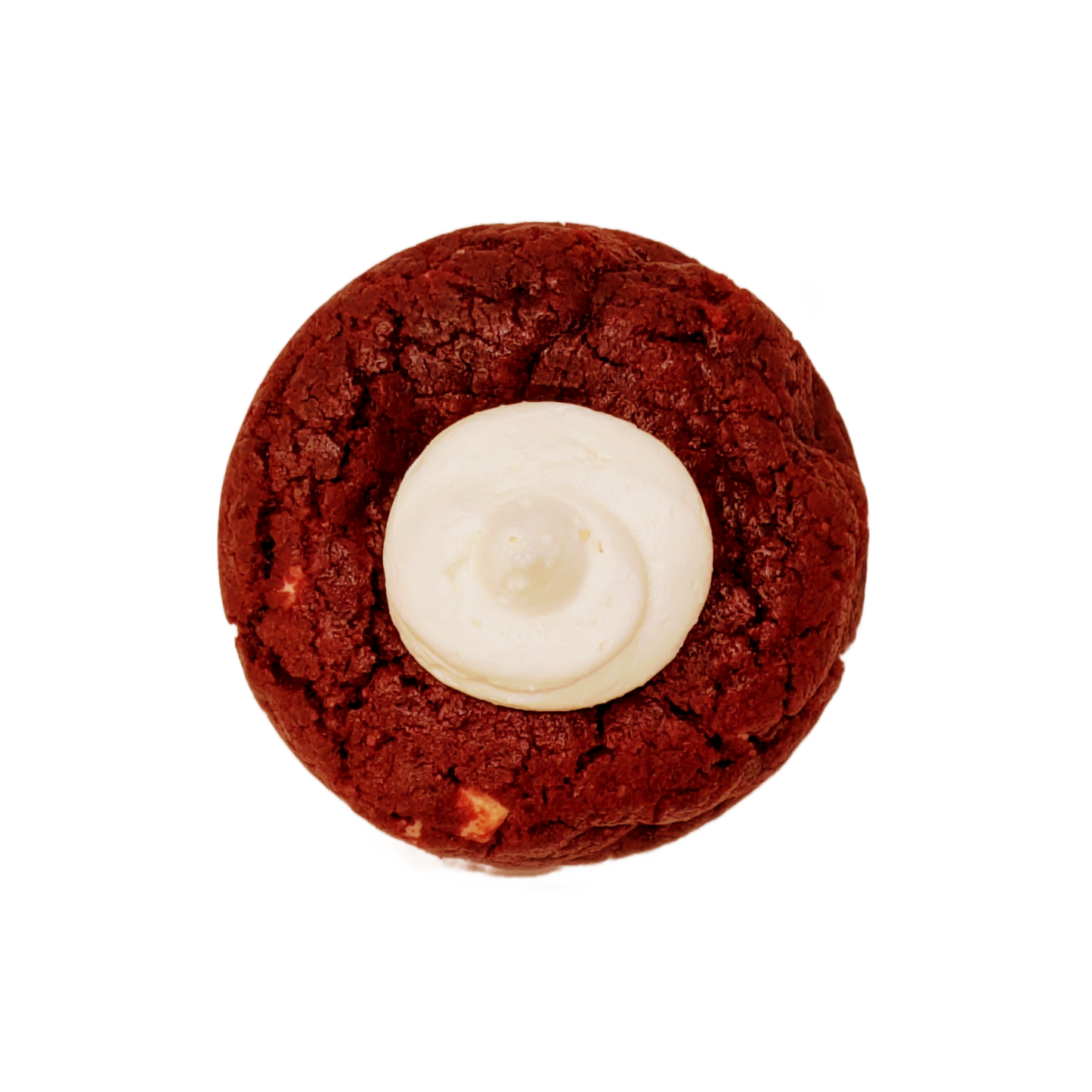 Picture of a red vanilla cookie stuffed with white chocolate chunks and a center topping of cream cheese