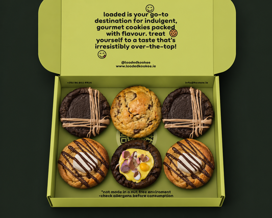 picture of a green open selection box showing the contents, six delicious stuffed cookies with various fillings and toppings